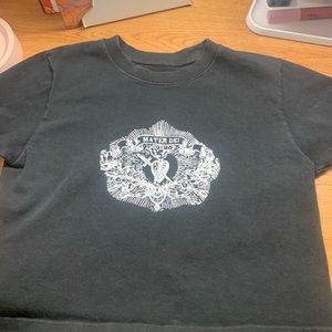 Black, cropped T shirt with white detail.